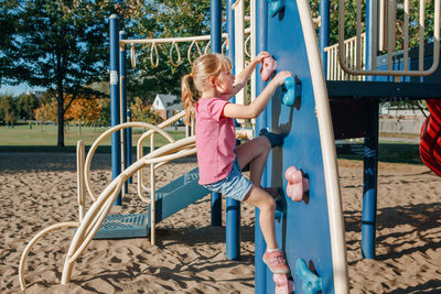 Full length of girl playing on playground