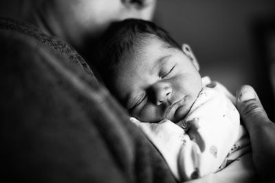 Midsection of father holding daughter at home