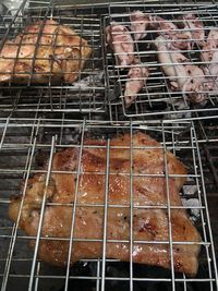 High angle view of meat on barbecue grill
