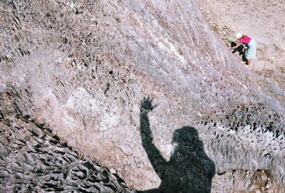 High angle view of woman standing on rock formation