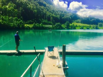 Scenic view of swimming pool by lake against sky