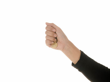 Close-up of hand holding paper over white background