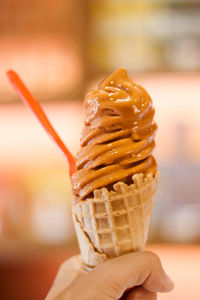 Close-up of hand holding ice cream