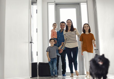 Side view of family walking at home