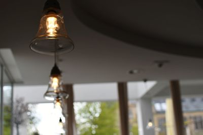 Low angle view of illuminated light bulb in building