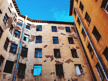 Low angle view of old building against blue sky