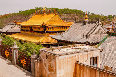 View over the golden roofs of the tibetan monastery complex ta'er kumbum near xining, china