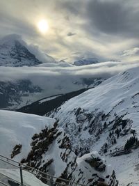 Scenic view of snow covered mountains against sky