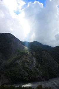 Scenic view of mountains against cloudy sky