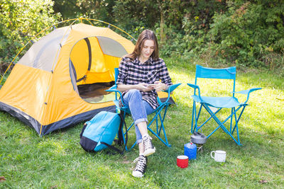 High angle view of woman sitting on tent