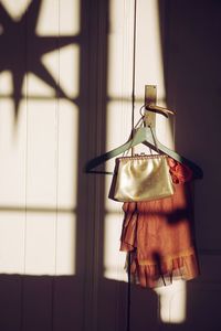 Dress with purse hanging on cabinet at home