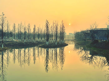 Scenic view of lake against sky during sunset