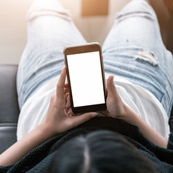 Midsection of man using mobile phone