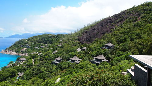 Scenic view of sea and mountains against sky