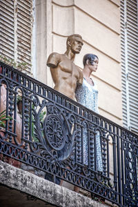 Low angle view of female statue against building