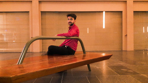 Portrait of young man sitting on seat