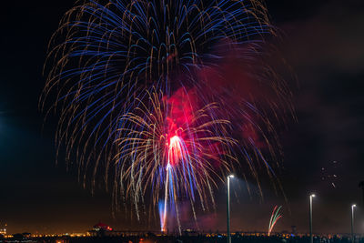 Low angle view of firework display at night