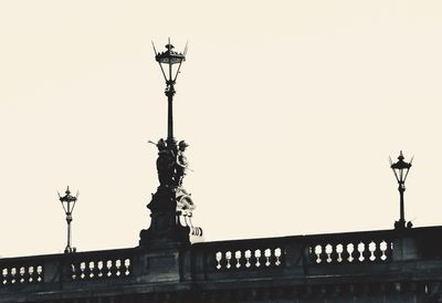 Low angle view of silhouette statue against sky