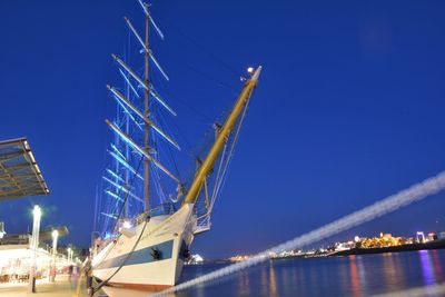 Scenic view of cruise ships in sea at night