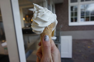 Close-up of hand holding ice cream cone