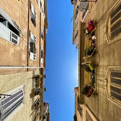 Low angle view of buildings against blue sky