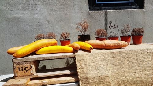 Various fruits on table against wall