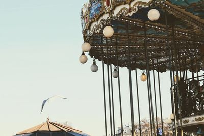 Low angle view of ferris wheel against clear sky