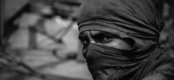 Close-up portrait of woman wearing mask outdoors