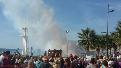 Crowd in city against sky