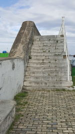 Low angle view of old ruin building against cloudy sky