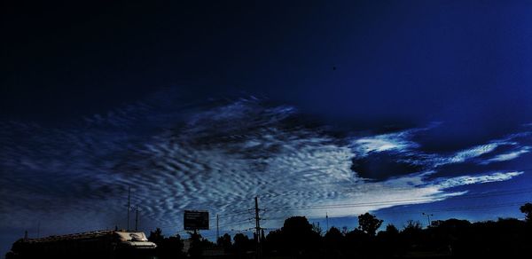 Low angle view of silhouette trees against sky at night