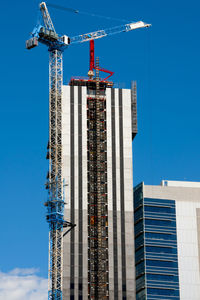 Low angle view of building against clear blue sky