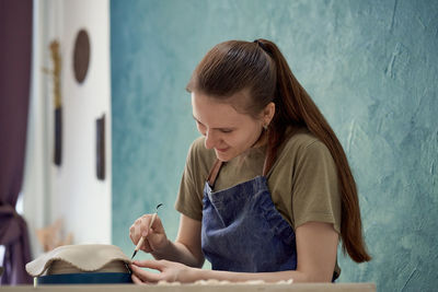 Young woman reading book on table