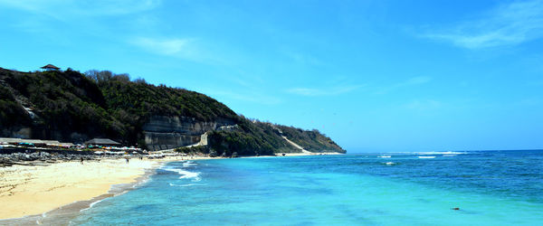 Scenic view of sea against blue sky