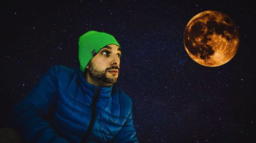 Portrait of man against moon