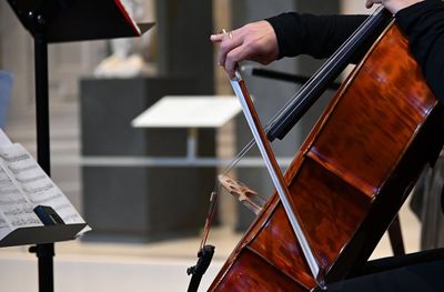 Midsection of person playing string instrument