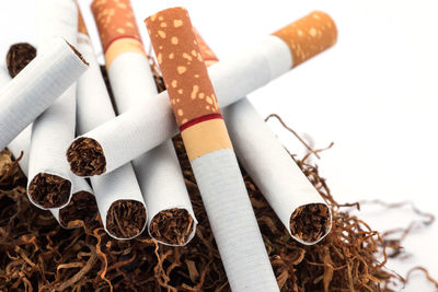 Close-up of cigarettes on white background