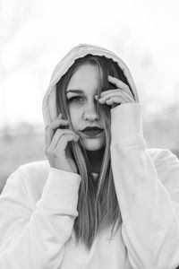 Portrait of young woman wearing hood