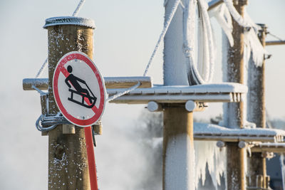 Low angle view of sign against sky