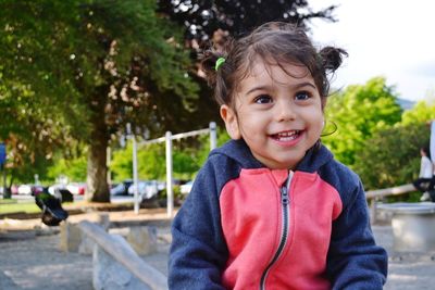 Smiling cute girl looking away at playground