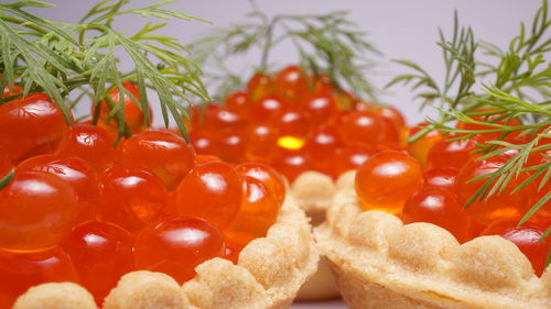 Close-up of red caviar on white background