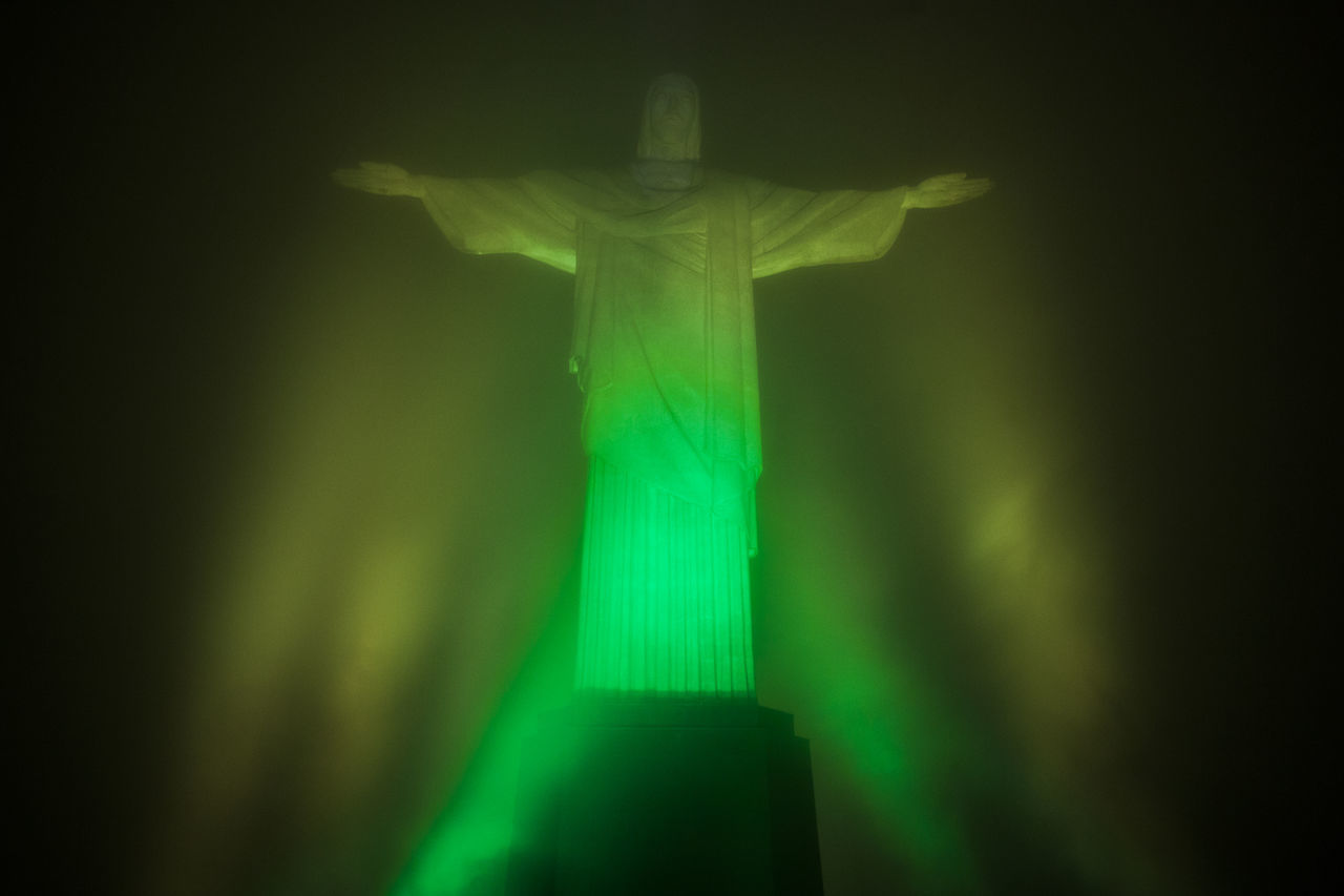 ILLUMINATED STATUE AGAINST SKY