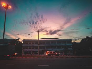 Cars on city street at dusk