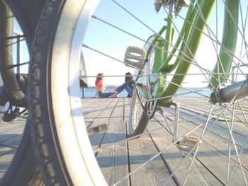 People working on wheel against sky