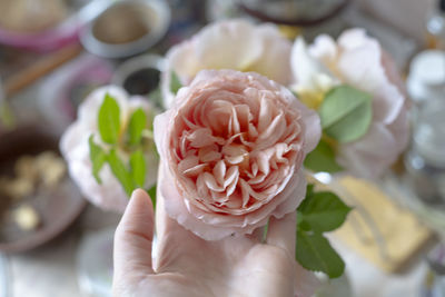 Close-up of hand holding rose bouquet