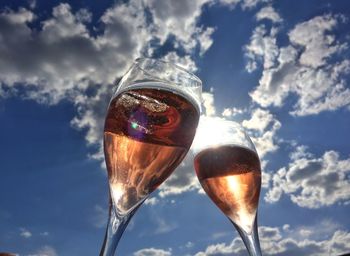 Low angle view of wine glass against sky