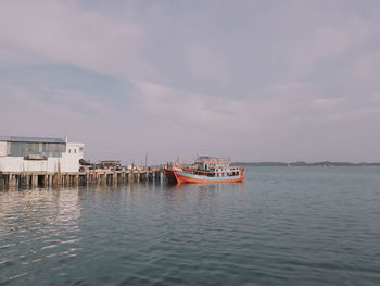 Fishing boat in sea against sky