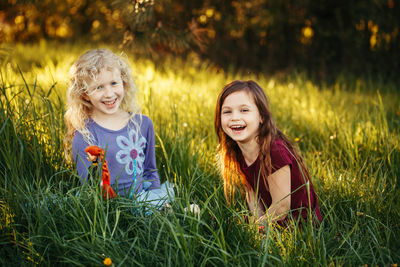 Portrait of smiling girl on grassy field