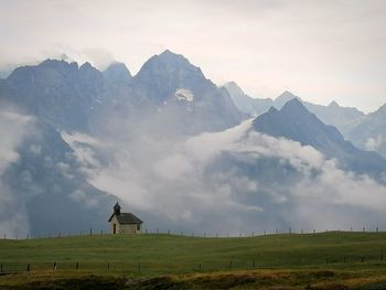 Scenic view of field and mountains against sky