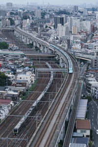 High angle view of trains on railroad tracks amidst buildings in city